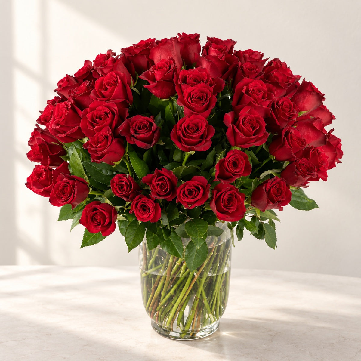 AI-assisted photo-style preview of 75 Explorer Red Roses in a Glass Vase – Toronto Delivery as shown; actual arrangement and proportions vary.