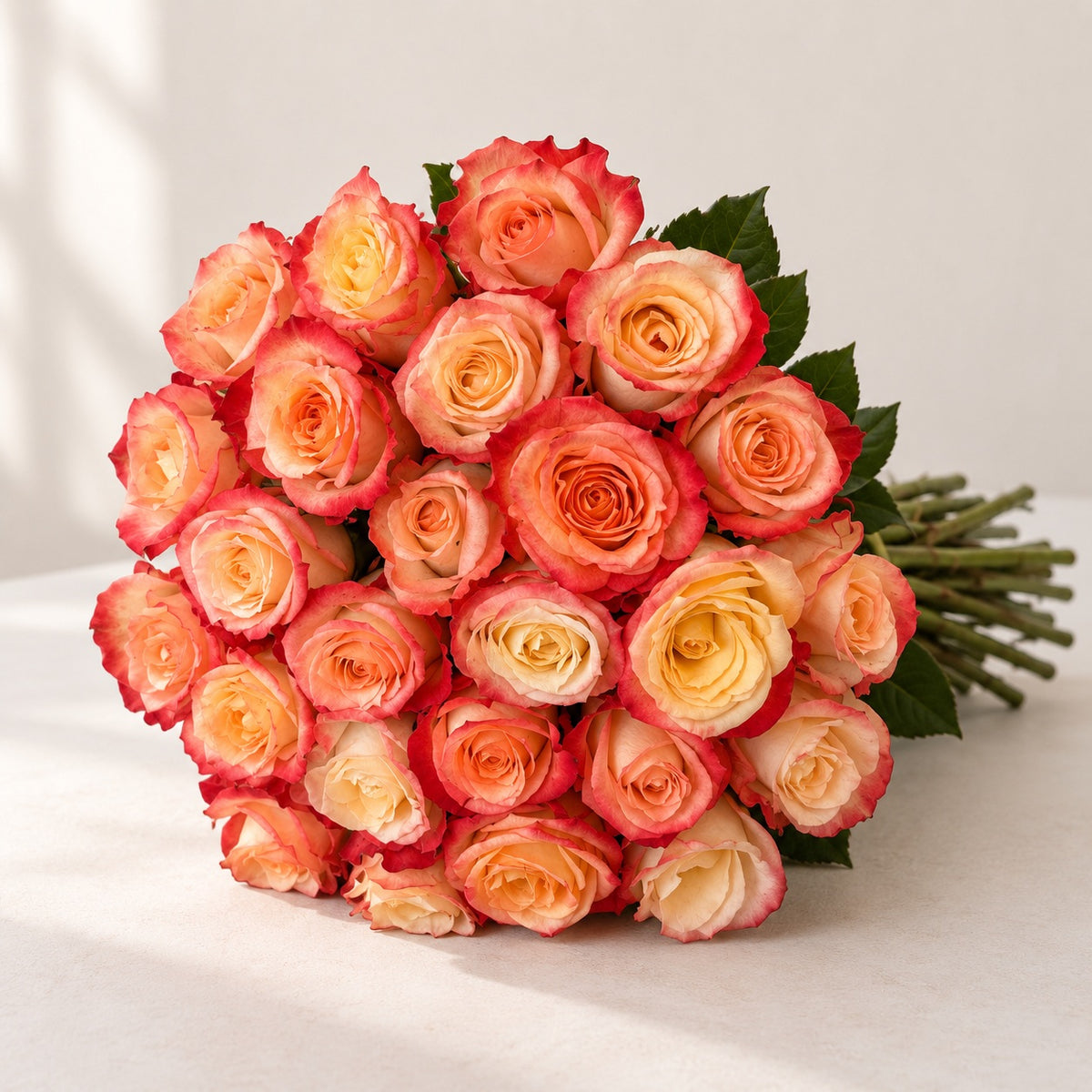 AI-assisted photo-style preview of 'Cabaret' Peach Two Tone Roses, 25-rose option; actual arrangement and proportions vary.
