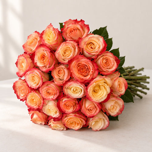 AI-assisted photo-style preview of 'Cabaret' Peach Two Tone Roses, 25-rose option; actual arrangement and proportions vary.