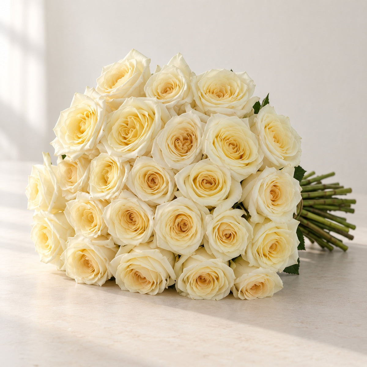 AI-assisted photo-style preview of 'Candlelight' Cream Two-Tone Roses, 25-rose option; actual arrangement and proportions vary.
