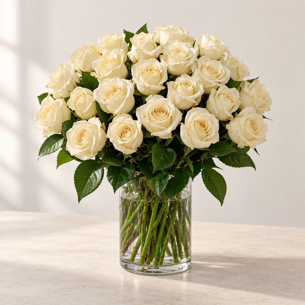 AI-assisted photo-style preview of 'Crem-de-la-Crem' Medium Stem Vase Arrangement, 25-rose option; actual arrangement and proportions vary.