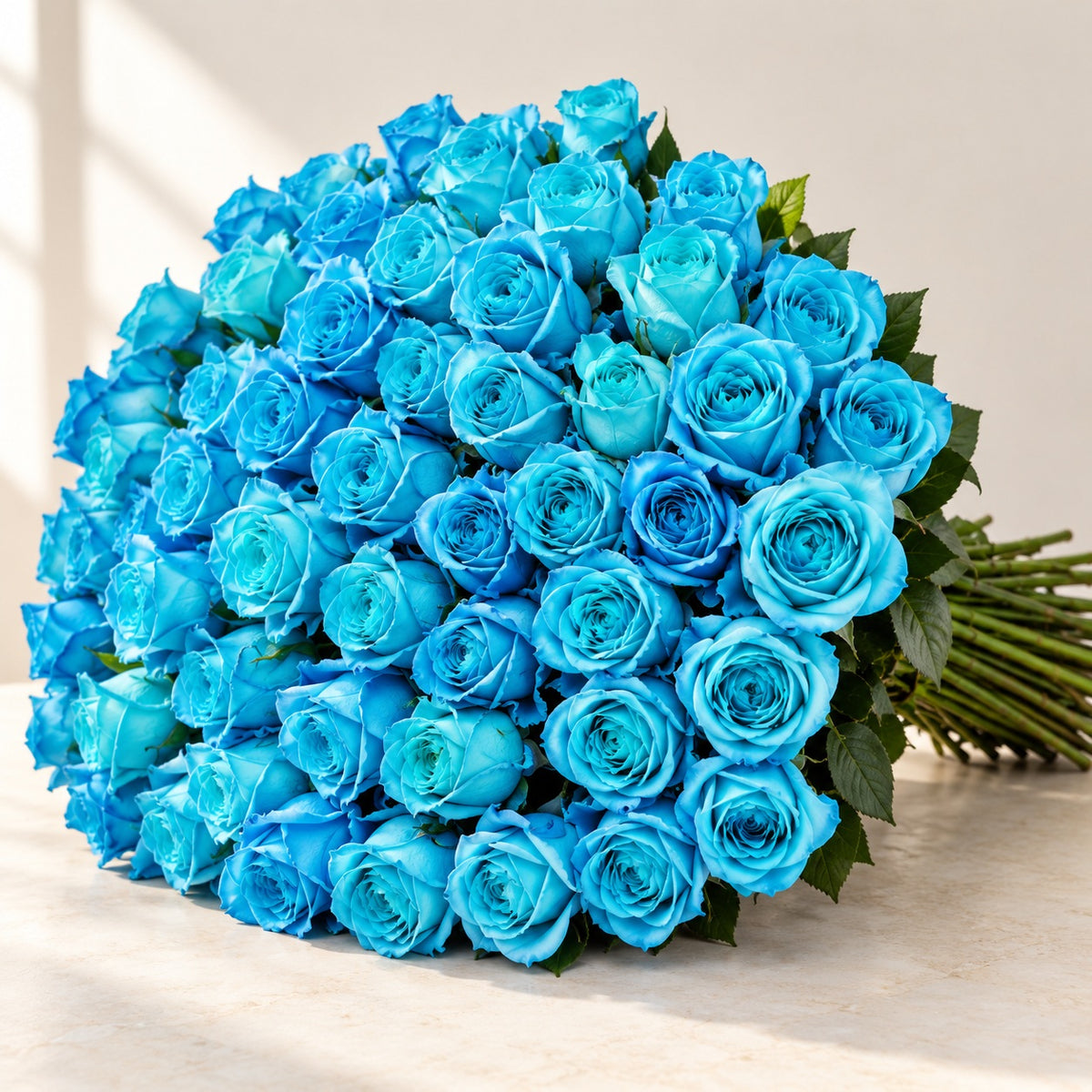 AI-assisted photo-style preview of 'Cyan' Blue Roses, 100-rose option; actual arrangement and proportions vary.