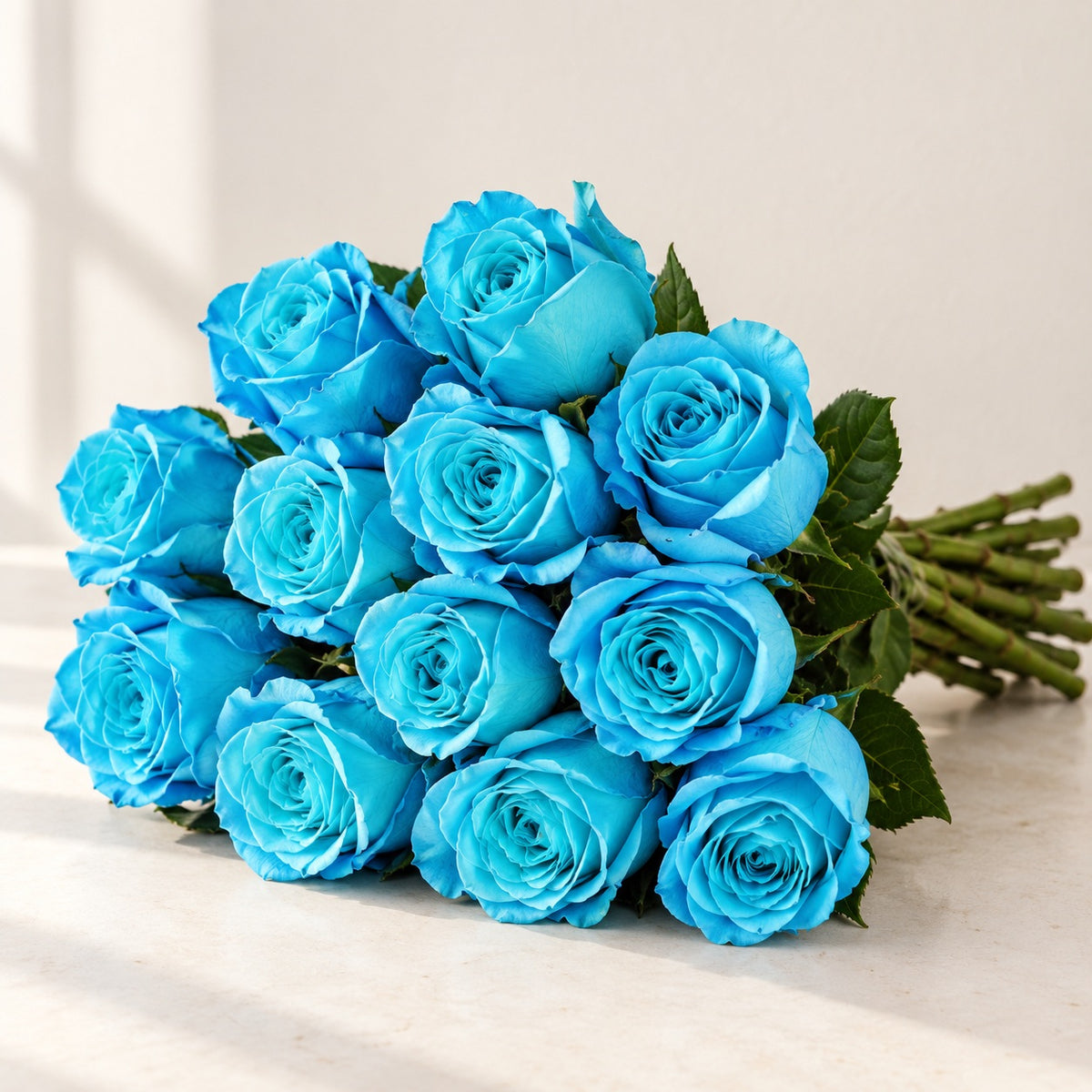AI-assisted photo-style preview of 'Cyan' Blue Roses, 12-rose option; actual arrangement and proportions vary.