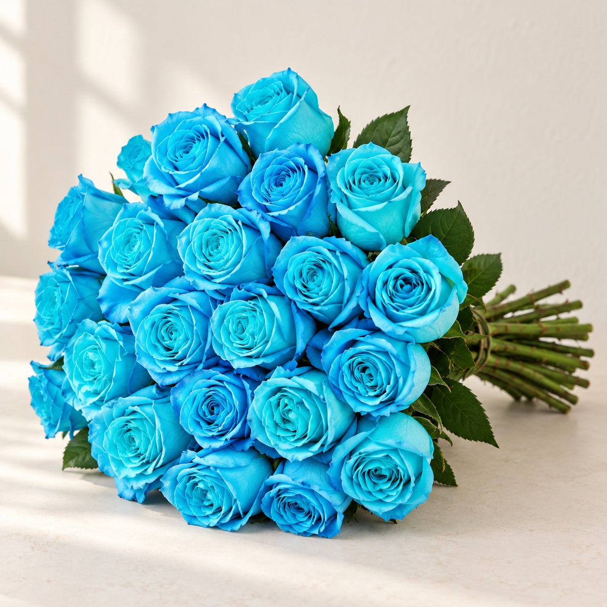 AI-assisted photo-style preview of 'Cyan' Blue Roses, 25-rose option; actual arrangement and proportions vary.