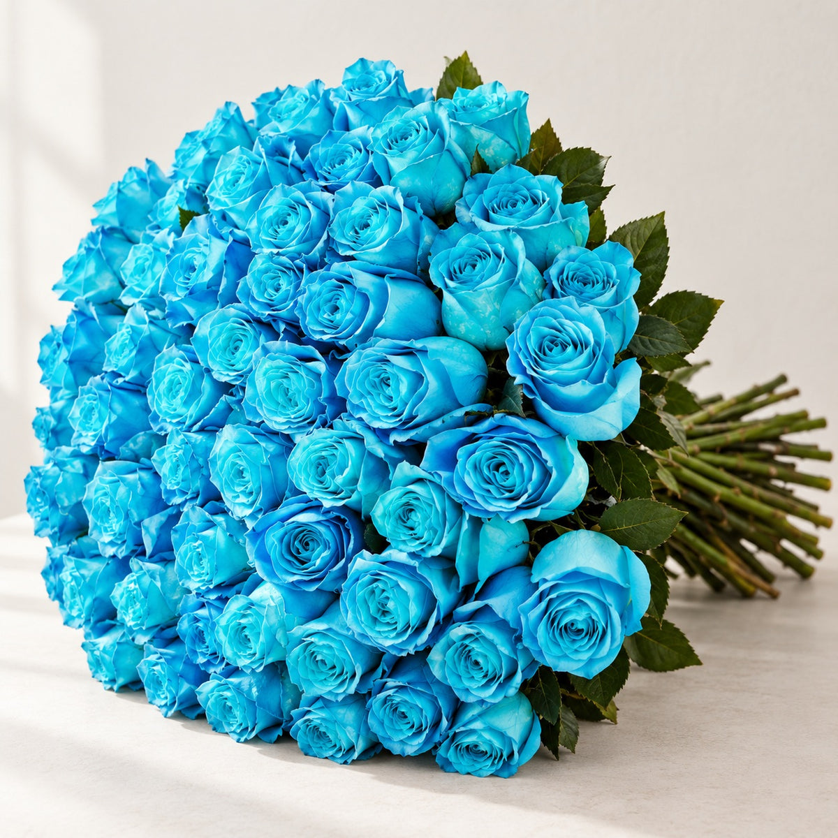 AI-assisted photo-style preview of 'Cyan' Blue Roses, 75-rose option; actual arrangement and proportions vary.