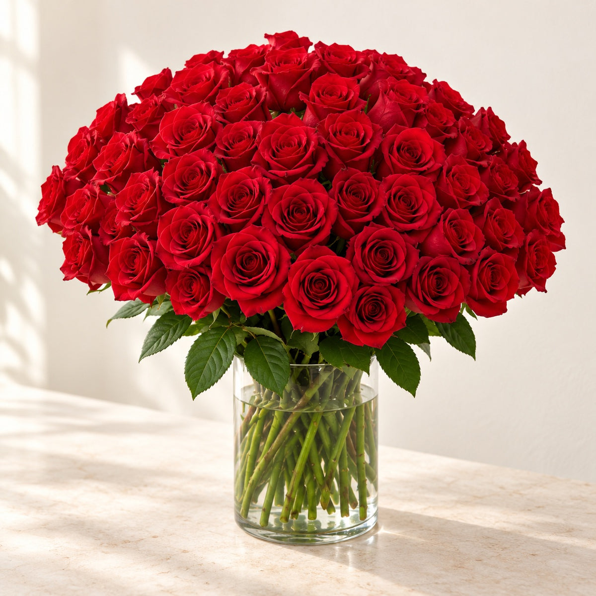 AI-assisted photo-style preview of 'Explorer' Medium Stem Vase Arrangement, 75-rose option; actual arrangement and proportions vary.