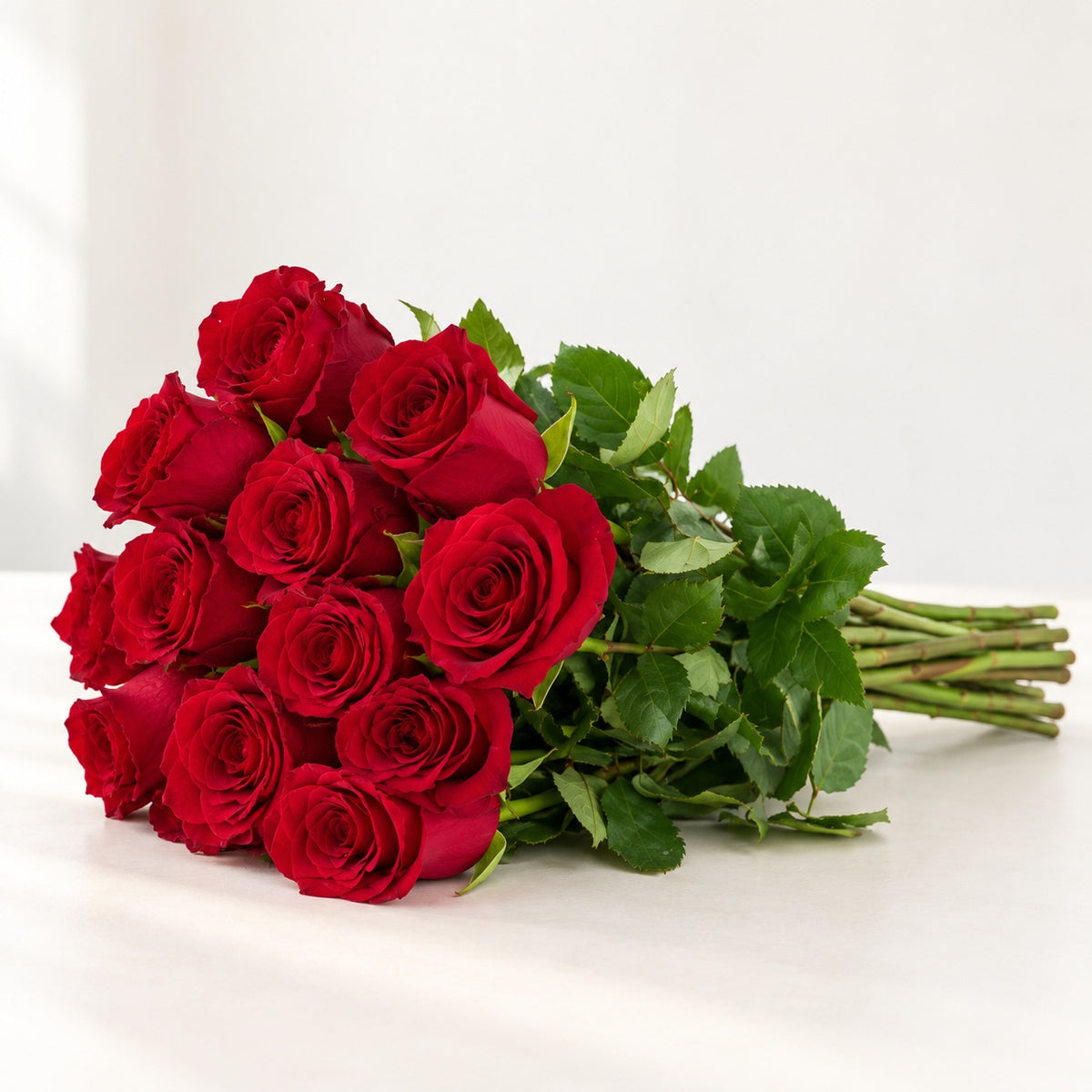 AI-assisted photo-style preview of 'Explorer' Red Roses, 12-rose option; actual arrangement and proportions vary.