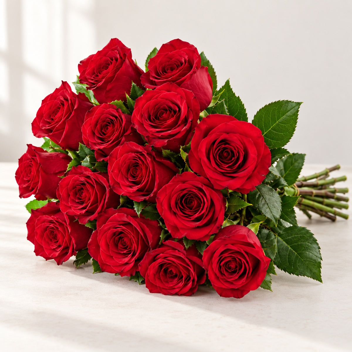 AI-assisted photo-style preview of 'Freedom' Red Rose, 12-rose option; actual arrangement and proportions vary.
