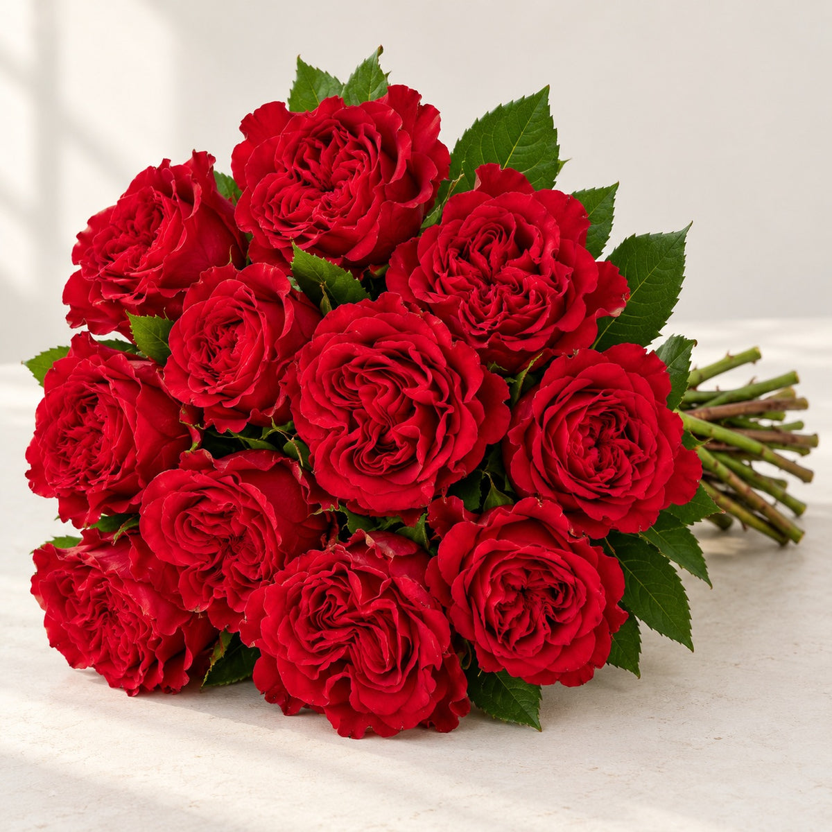 AI-assisted photo-style preview of 'Hearts' Red Roses, 12-rose option; actual arrangement and proportions vary.
