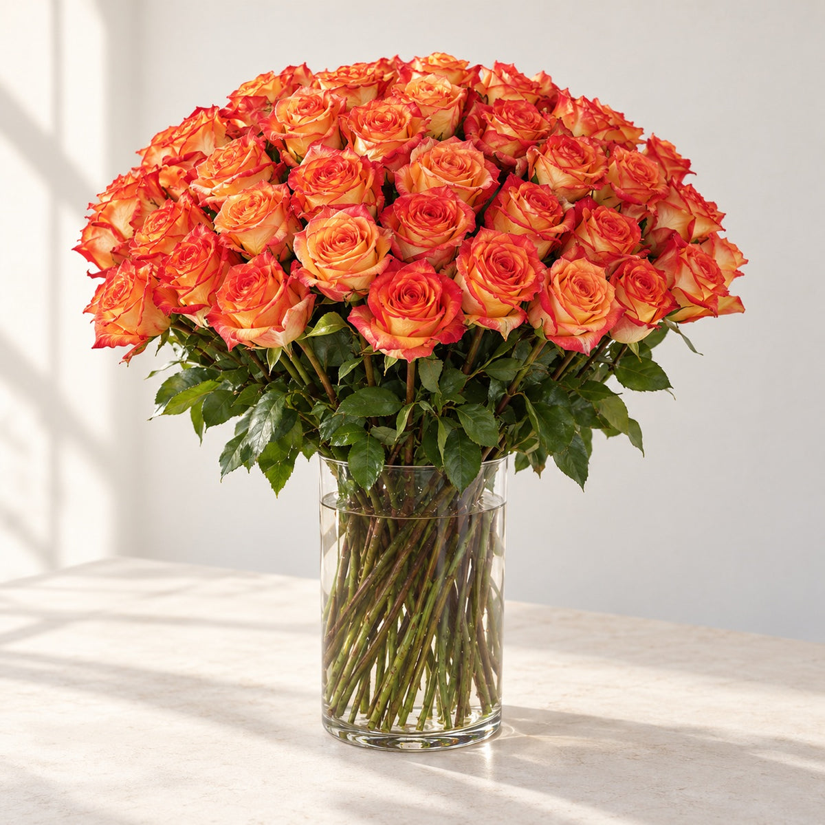 AI-assisted photo-style preview of 'High & Orange' Long Stem Vase Arrangement, 50-rose option; actual arrangement and proportions vary.