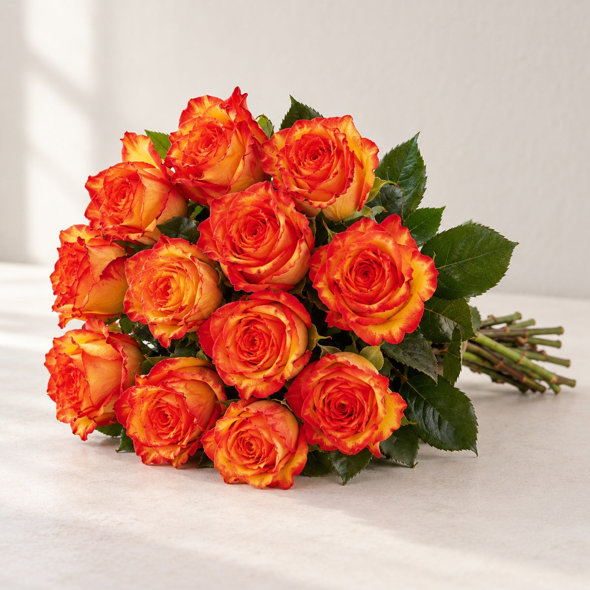 AI-assisted photo-style preview of 'High & Orange' Two Tone Orange Roses, 12-rose option; actual arrangement and proportions vary.