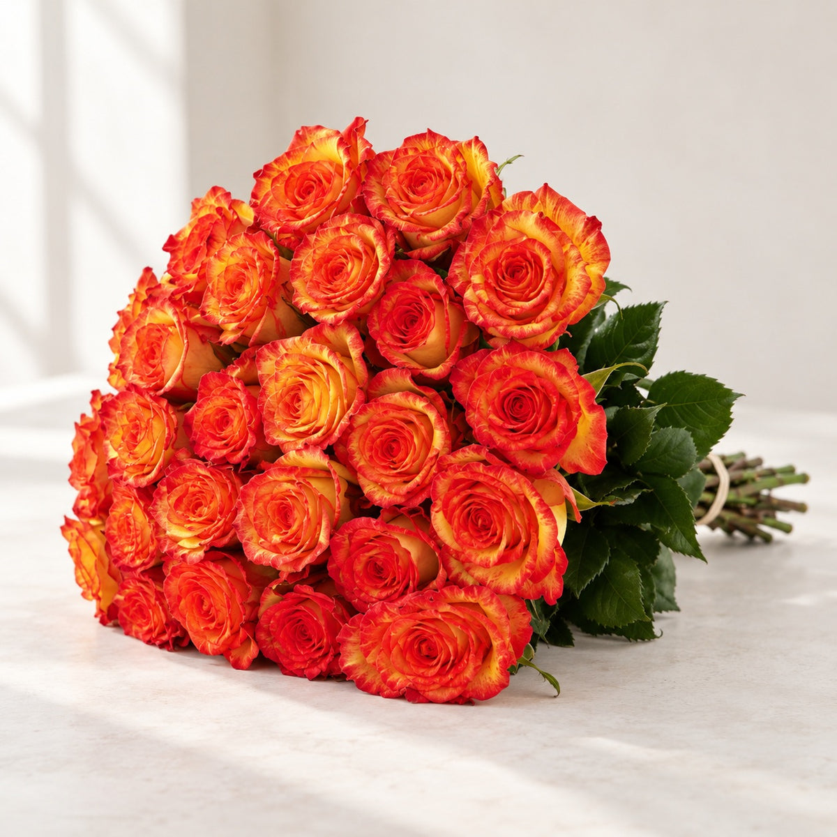 AI-assisted photo-style preview of 'High & Orange' Two Tone Orange Roses, 25-rose option; actual arrangement and proportions vary.