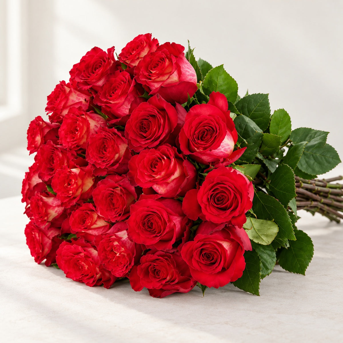 AI-assisted photo-style preview of 'Iguazu' Two Tone Red Roses, 25-rose option; actual arrangement and proportions vary.
