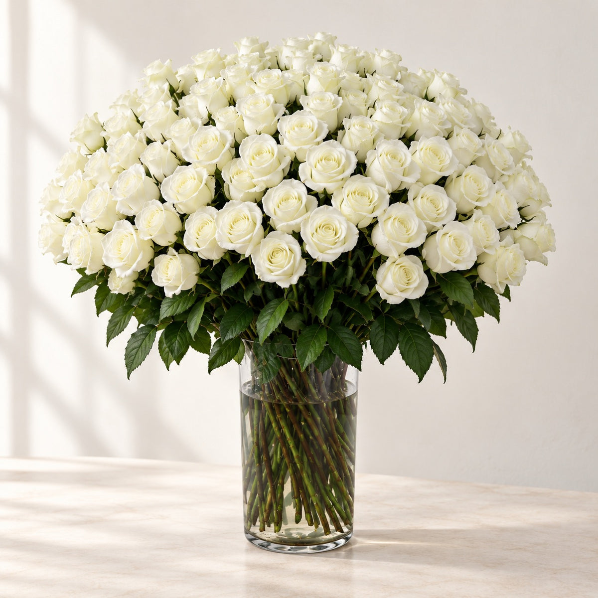 AI-assisted photo-style preview of 'MIA' XLong Stem Vase Arrangement, 100-rose option; actual arrangement and proportions vary.