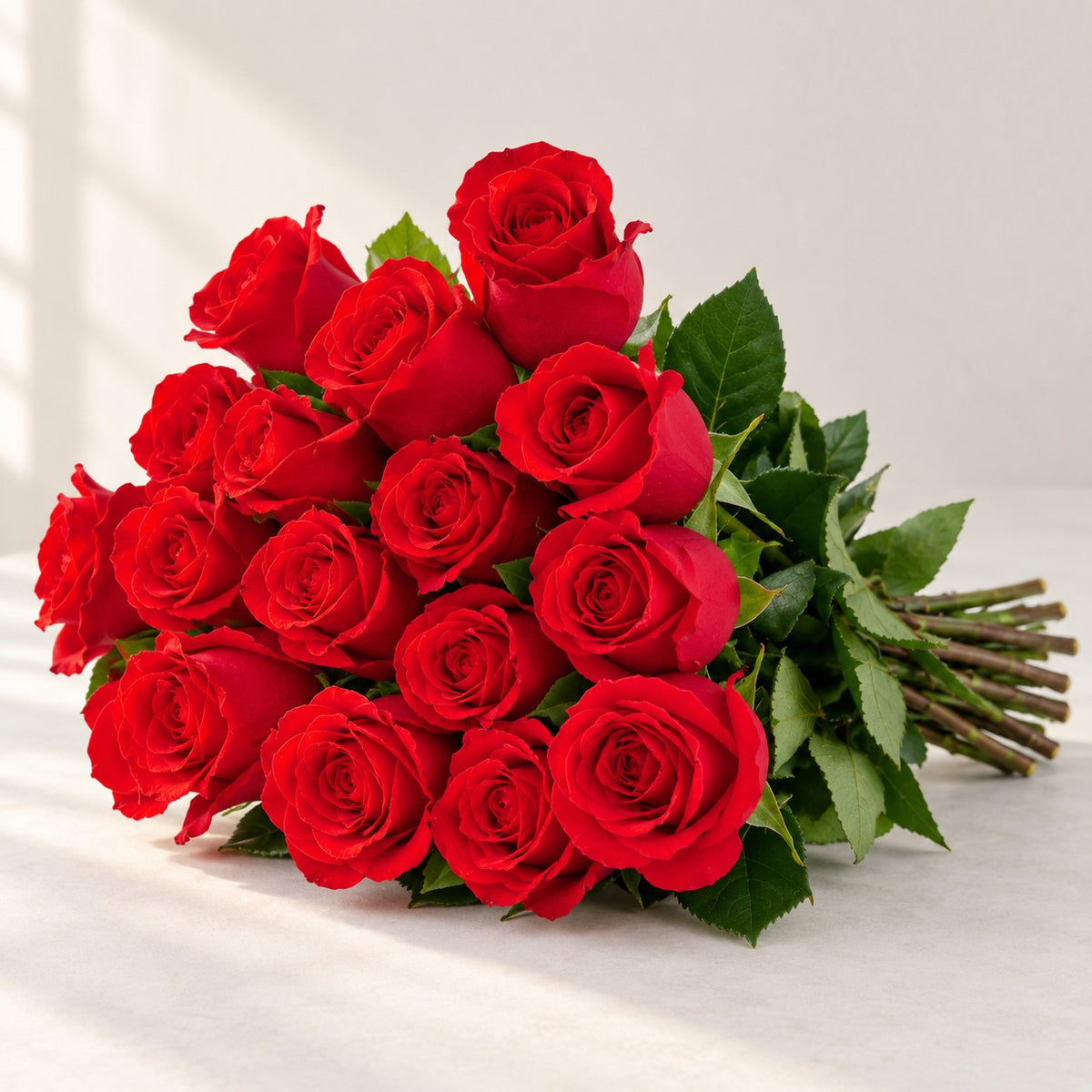 AI-assisted photo-style preview of 'Nina' Bright Red Roses, 12-rose option; actual arrangement and proportions vary.