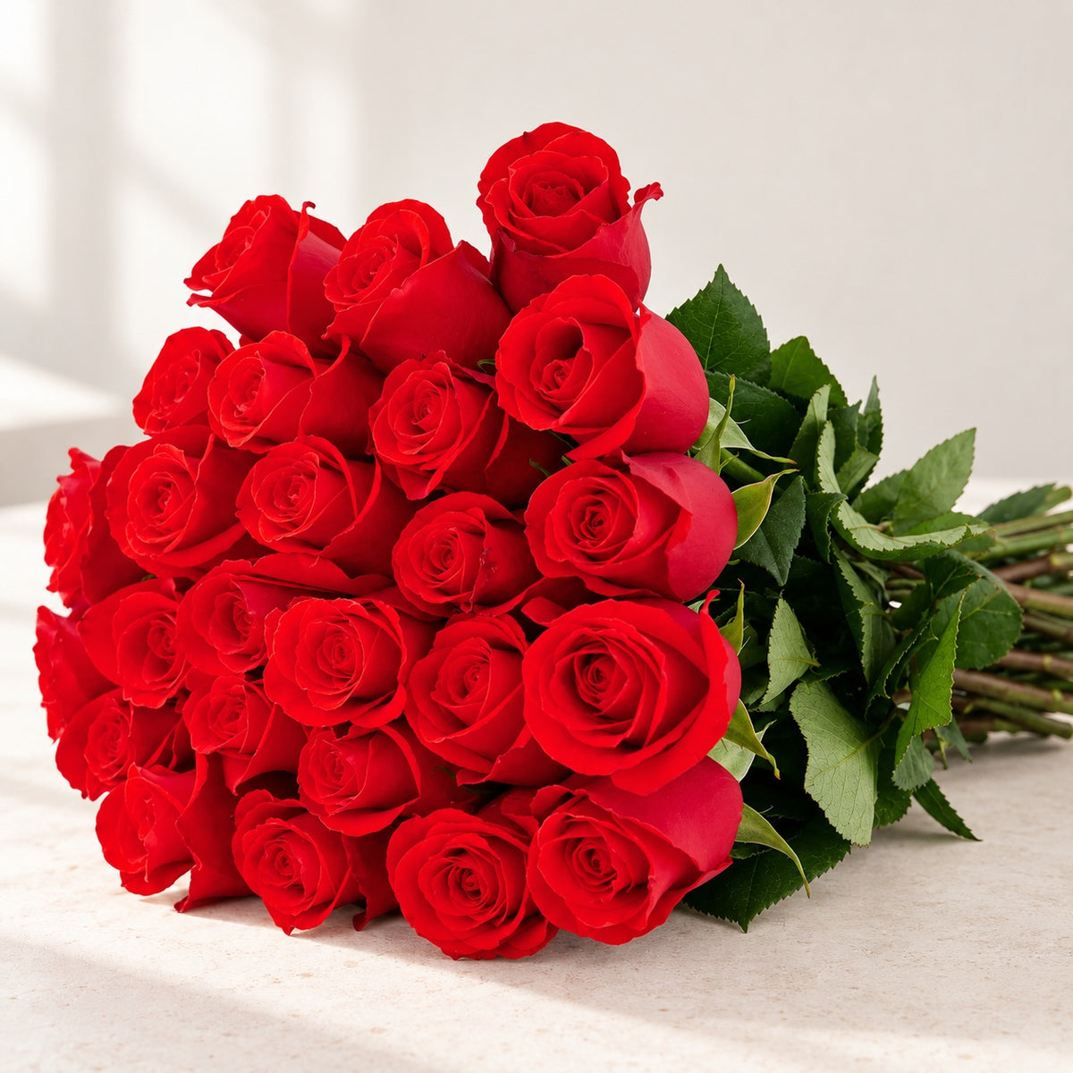 AI-assisted photo-style preview of 'Nina' Bright Red Roses, 25-rose option; actual arrangement and proportions vary.