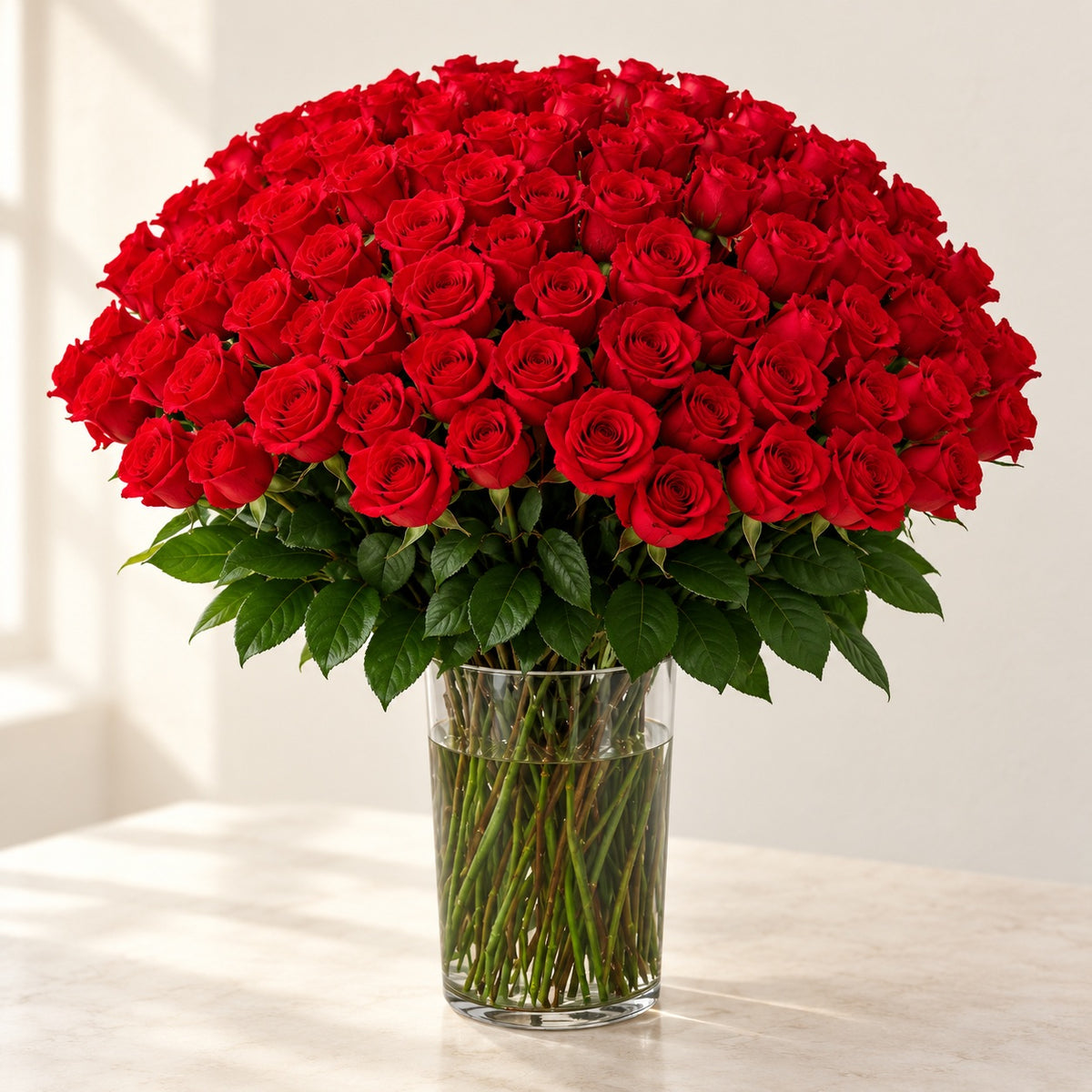 AI-assisted photo-style preview of 'Nina' XLong Stem Vase Arrangement, 100-rose option; actual arrangement and proportions vary.