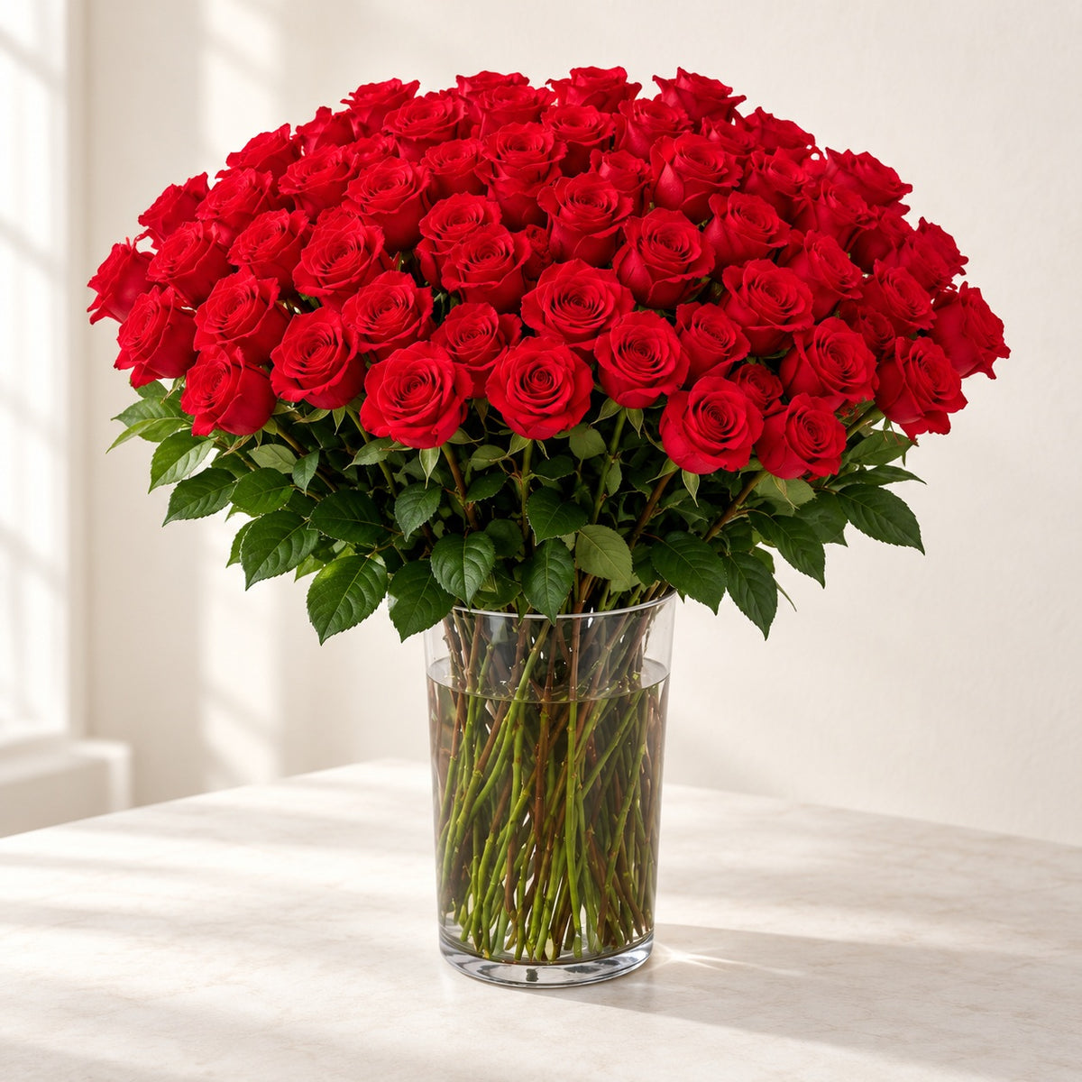 AI-assisted photo-style preview of 'Nina' XLong Stem Vase Arrangement, 75-rose option; actual arrangement and proportions vary.