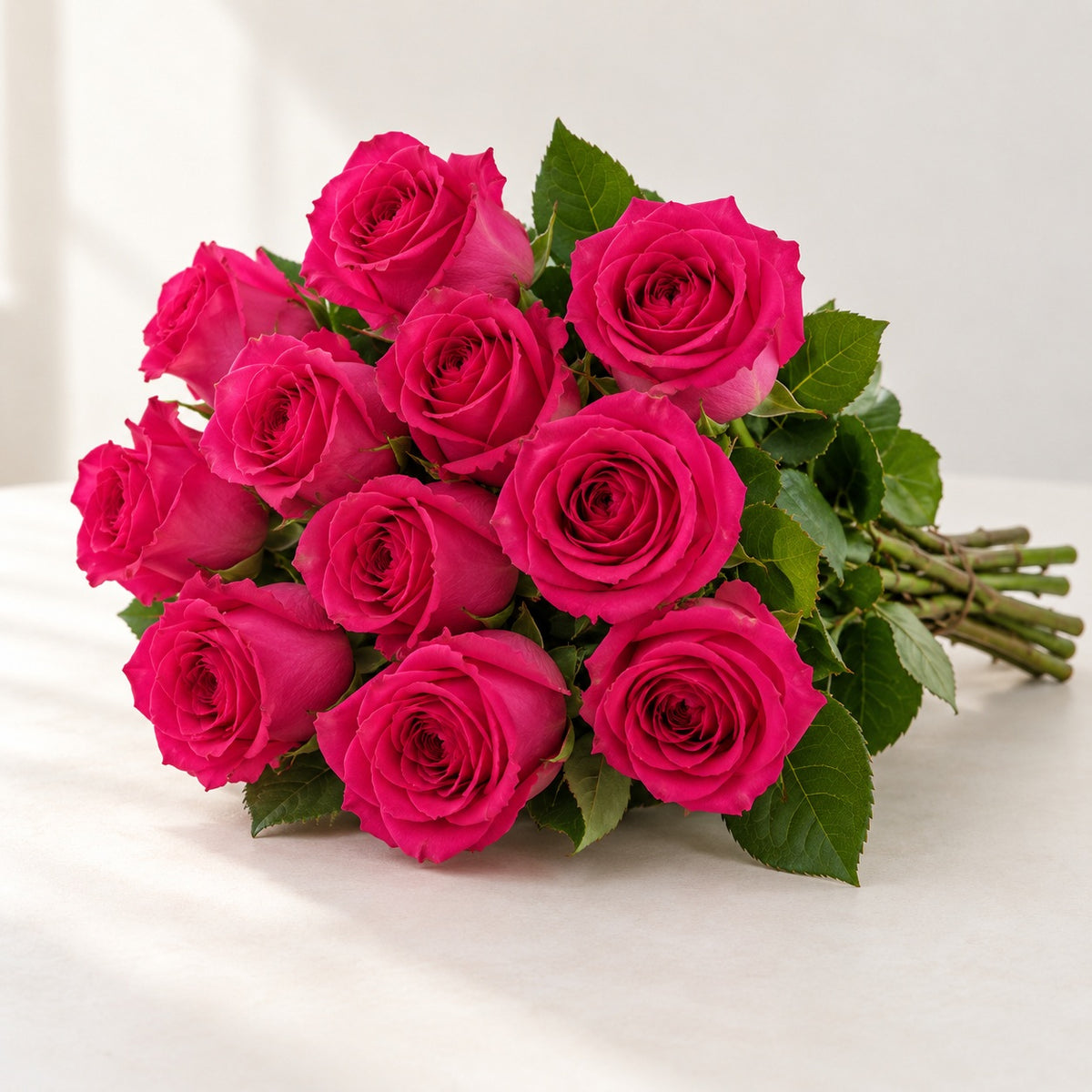 AI-assisted photo-style preview of 'Pink Floyd' Fuschia Roses, 12-rose option; actual arrangement and proportions vary.