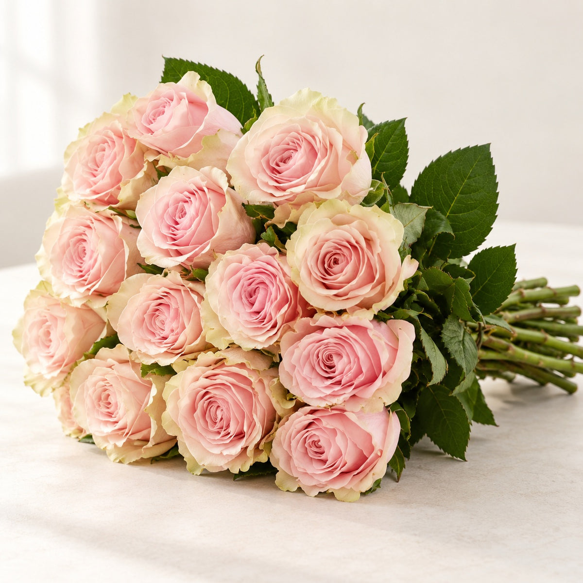 AI-assisted photo-style preview of 'Pink Mondial' Nude Roses, 12-rose option; actual arrangement and proportions vary.