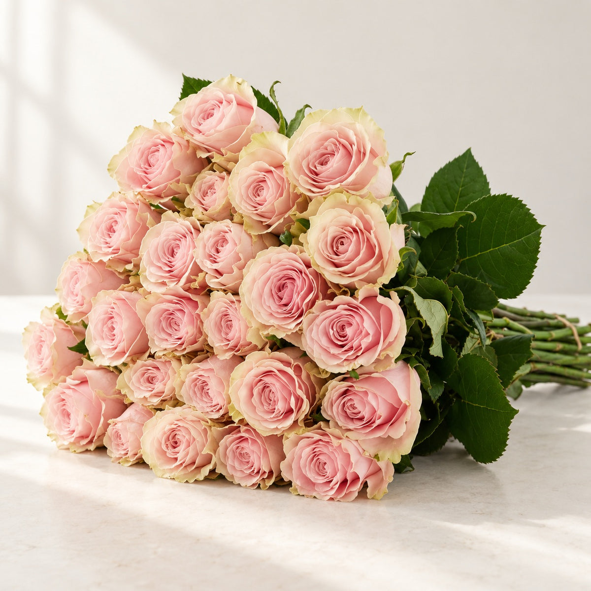 AI-assisted photo-style preview of 'Pink Mondial' Nude Roses, 25-rose option; actual arrangement and proportions vary.