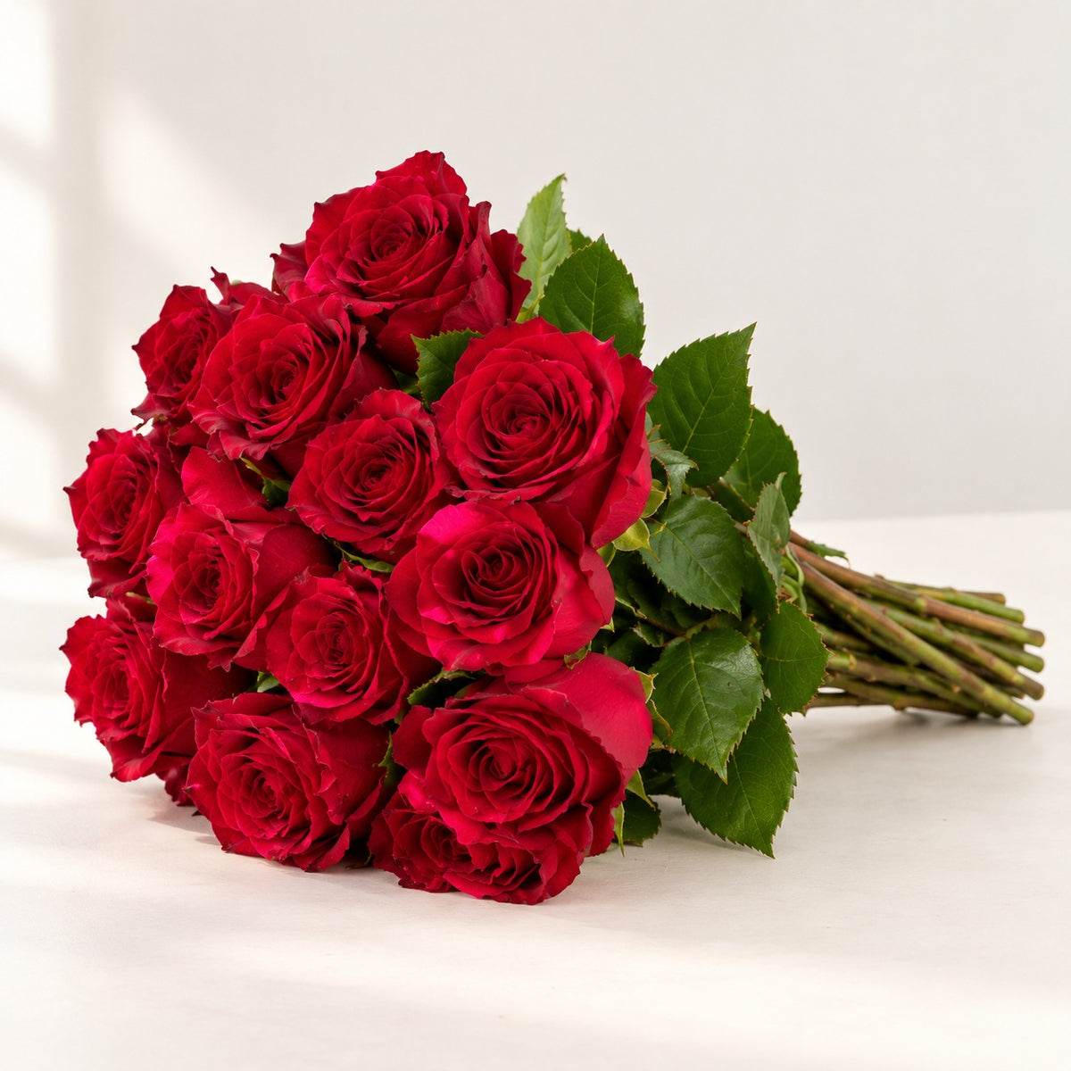 AI-assisted photo-style preview of 'Red Panther' Red Roses, 12-rose option; actual arrangement and proportions vary.