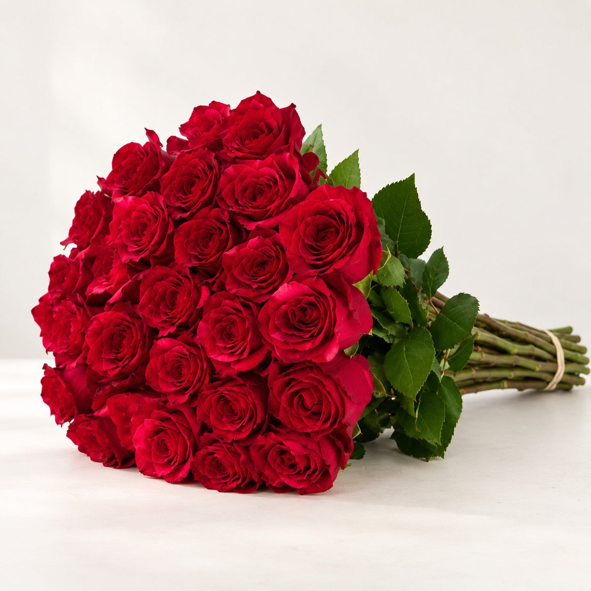 AI-assisted photo-style preview of 'Red Panther' Red Roses, 25-rose option; actual arrangement and proportions vary.