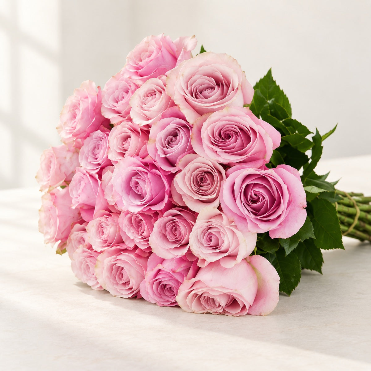 AI-assisted photo-style preview of 'Secret Garden' Light Pink bi-Color Roses, 25-rose option; actual arrangement and proportions vary.