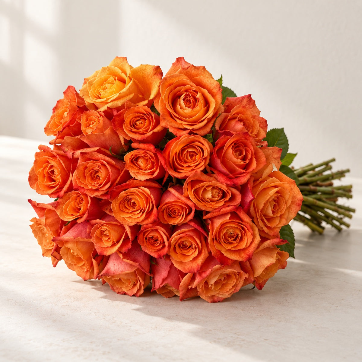 AI-assisted photo-style preview of 'Sunset Glory' Orange Roses, 25-rose option; actual arrangement and proportions vary.